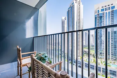 a balcony with a bench and views of skyscrapers at Charming 1BR Apartment in Creek Edge Tower 1, Dubai Creek Harbor by Deluxe Holiday Homes in Dubai