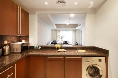 a kitchen with a washer and dryer on a counter at Bespoke Holiday Homes - Palm Jumeirah- 1 Bedroom North Residence in Dubai