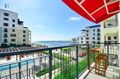 a balcony with a view of the water and buildings at Luxury Escapes - Sea View 1Bed Apartment in Port de Lamer in Dubai