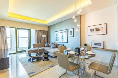 a living room with a couch and a table at Dubai Dreaming Stylish 1BR, DAMAC Towers Paramount in Dubai