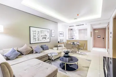 a living room with a couch and a table at Dubai Dreaming Stylish 1BR, DAMAC Towers Paramount in Dubai