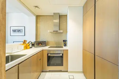 a kitchen with a sink and a stove at Dubai Dreaming Stylish 1BR, DAMAC Towers Paramount in Dubai