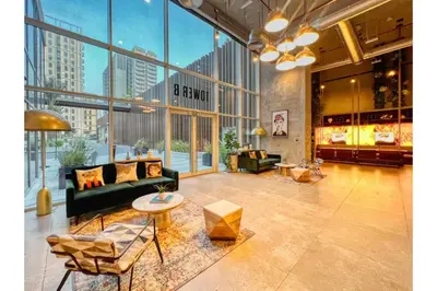 a living room with a couch and a table at HAVN - 1 Bedroom in Collective, Dubai Hills Estate in Dubai
