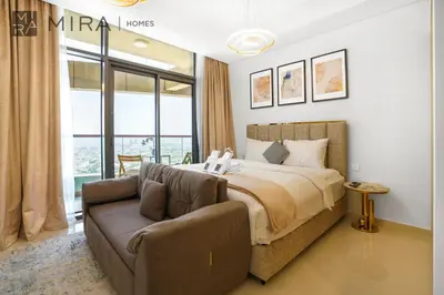 a bedroom with a bed and a couch at Mira Holiday Homes - Fully Furnished Studio in Business Bay in Dubai