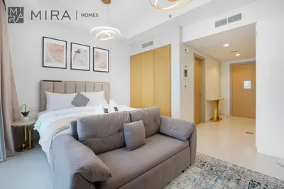 a bedroom with a large bed and a couch at Mira Holiday Homes - Fully Furnished Studio in Business Bay in Dubai