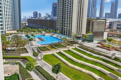 an aerial view of a pool in a city with tall buildings at Apartment in Downtown Dubai (Burj Khalifa Views) in Dubai