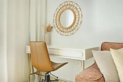 a desk with a chair and a mirror on a wall at Apartment in Downtown Dubai (Burj Khalifa Views) in Dubai