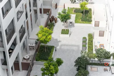 an aerial view of a building with trees and plants at HAVN - 1 Bedroom in Bayshore 2, Creek Beach in Dubai