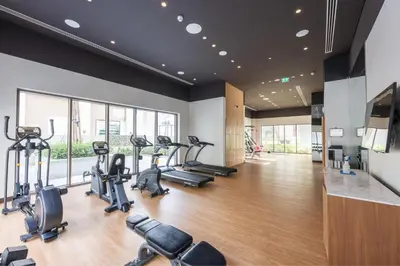 a gym with treadmills and cardio machines in a room at HAVN - 1 Bedroom in Bayshore 2, Creek Beach in Dubai