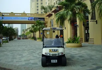 a small golf cart parked in front of a building at JBR Walk Full Apartment Marina View in Dubai