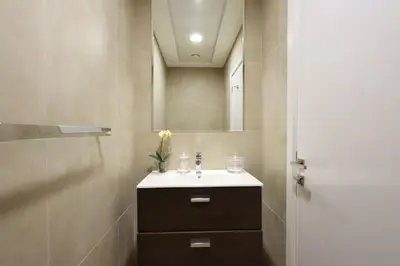 a bathroom with a sink and a mirror at 2BR in Central Marina Walk to Dining & Nightlife in Dubai