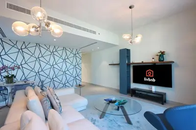 a living room with a couch and a tv at 2BR in Central Marina Walk to Dining & Nightlife in Dubai