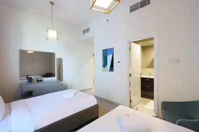 a hotel room with a bed and a bathroom at 2BR in Central Marina Walk to Dining & Nightlife in Dubai