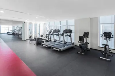 a gym with treadmills and machines in a building at 2BR in Central Marina Walk to Dining & Nightlife in Dubai