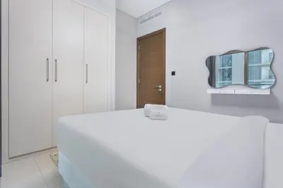 a white bathroom with a mirror and a white tub at STAY BY LATINEM Luxury 1BR Holiday Home CVR A2003 near Burj Khalifa in Dubai