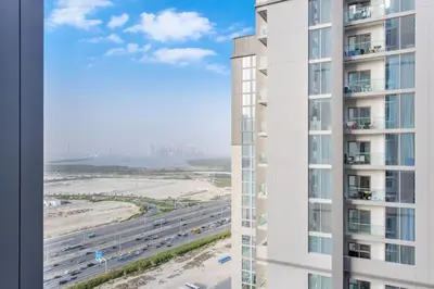 an aerial view of a building and a highway at STAY BY LATINEM Luxury 1BR Holiday Home CVR A2003 near Burj Khalifa in Dubai