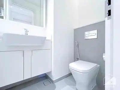 a white bathroom with a sink and a toilet at Modern 1-Bedroom Haven in Ahad Residence in Dubai