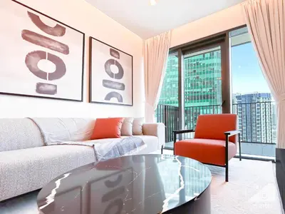 a living room with a couch and a table at Modern 1-Bedroom Haven in Ahad Residence in Dubai