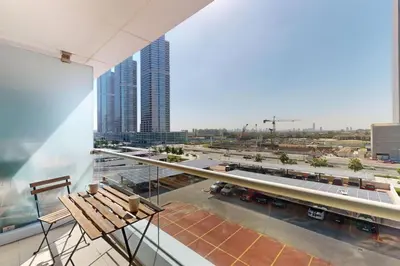 a balcony with a bench and a parking lot at Goldcrest Views 2 - Elegant Studio in Dubai