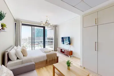 a bedroom with a bed and a large window at Goldcrest Views 2 - Elegant Studio in Dubai