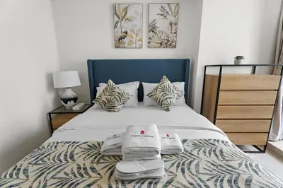 a bedroom with a bed with towels on it at Stonetree - GoldCrest Views 2 - Peaceful Community in Dubai
