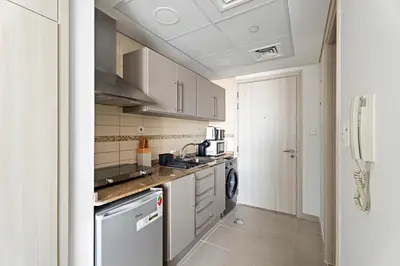 a small kitchen with a sink and a dishwasher at Stonetree - GoldCrest Views 2 - Peaceful Community in Dubai