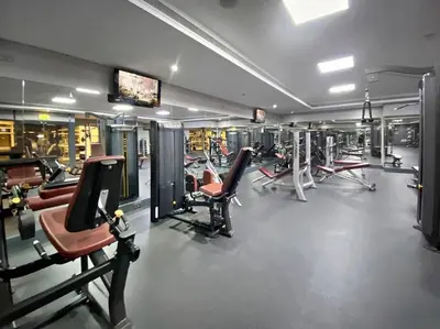 a gym with several rows of chairs and machines at Stonetree - GoldCrest Views 2 - Peaceful Community in Dubai