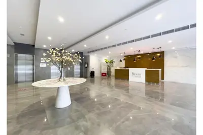 a lobby with a table with a tree on it at HAVN - Studio Apartment in Bloom Towers, JVC in Dubai