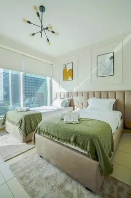 a bedroom with two beds and a ceiling fan at Brand New 2BHK Luxury Apartment 7min to Dubai Mall 1.5 Bath in Dubai