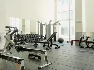 a gym with a large room with many machines at Brand New 2BHK Luxury Apartment 7min to Dubai Mall 1.5 Bath in Dubai
