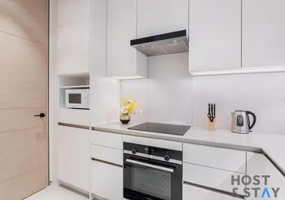 a kitchen with white cabinets and a stove top oven at Highfloor 2-BR in Address Jumeirah Beach Residence in Dubai