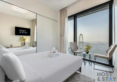 a hotel room with two beds and a large window at Highfloor 2-BR in Address Jumeirah Beach Residence in Dubai