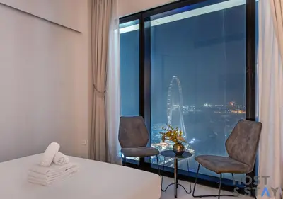 a room with two chairs and a window with a view at Highfloor 2-BR in Address Jumeirah Beach Residence in Dubai