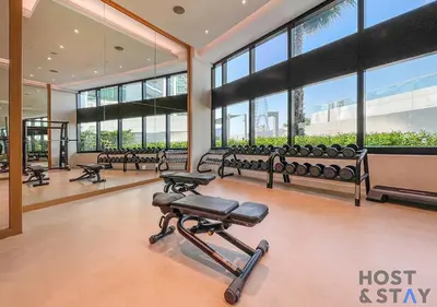 a gym with a row of benches and windows at Highfloor 2-BR in Address Jumeirah Beach Residence in Dubai