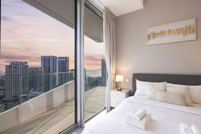 a bedroom with a bed and a large window at Stella Maris - Beachfront Premium 3 Bedroom Apt in Dubai