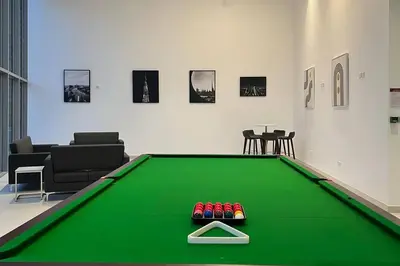 a green pool table with four balls on top of it at Stella Maris - Beachfront Premium 3 Bedroom Apt in Dubai