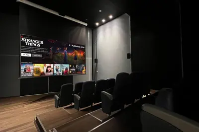 a cinema room with chairs and a large screen at Stella Maris - Beachfront Premium 3 Bedroom Apt in Dubai