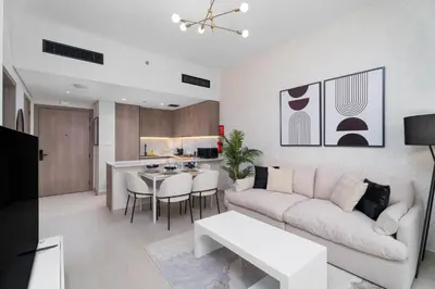 a living room with a white couch and a table at Nasma Luxury Stays - Laya Heights in Dubai