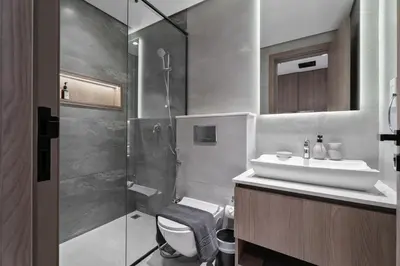 a bathroom with a toilet and a sink and a shower at Nasma Luxury Stays - Laya Heights in Dubai