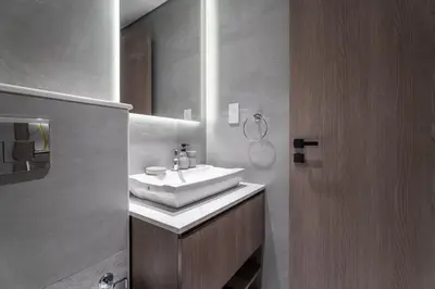 a bathroom with a white sink and a mirror at Nasma Luxury Stays - Laya Heights in Dubai