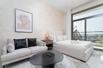 a living room with a bed and a couch at Nasma Luxury Stays - Laya Heights in Dubai