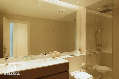 a bathroom with a sink and a toilet and a mirror at Veluxa - Stunning Sea View - Luxe 3 Bed in La Mer in Dubai