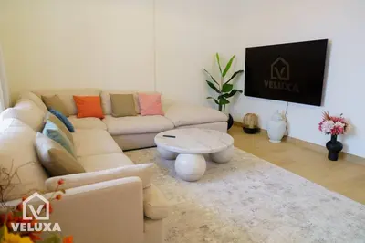 a living room with a couch and a table at Veluxa - Stunning Sea View - Luxe 3 Bed in La Mer in Dubai