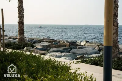 a view of the ocean from a beach with rocks at Veluxa - Stunning Sea View - Luxe 3 Bed in La Mer in Dubai