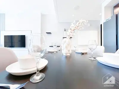 a dining room table with wine glasses and plates at Luxury & Elegance at Burj Crown Downtown in Dubai