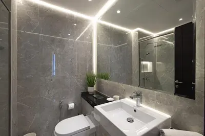 a bathroom with a sink and a toilet and a mirror at Luxe 2-Bedroom In Heart Of Dubai Marina in Dubai