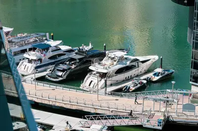 a group of boats are docked at a dock at Luxe 2-Bedroom In Heart Of Dubai Marina in Dubai