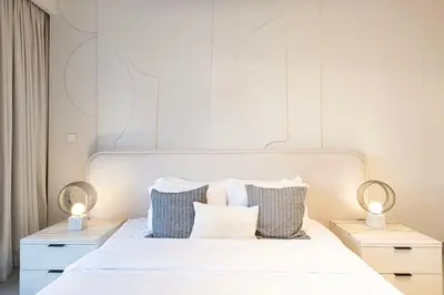 a bedroom with a white bed with two lamps at Stunning Burj & Fountain Views Luxury 2 BR in Dubai