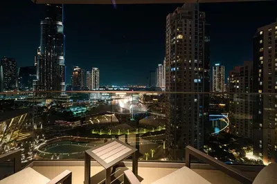 a view of a city skyline at night at Stunning Burj & Fountain Views Luxury 2 BR in Dubai