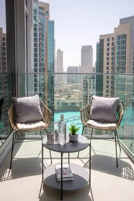 a balcony with two chairs and a table at Frank Porter - Opera Grand in Dubai